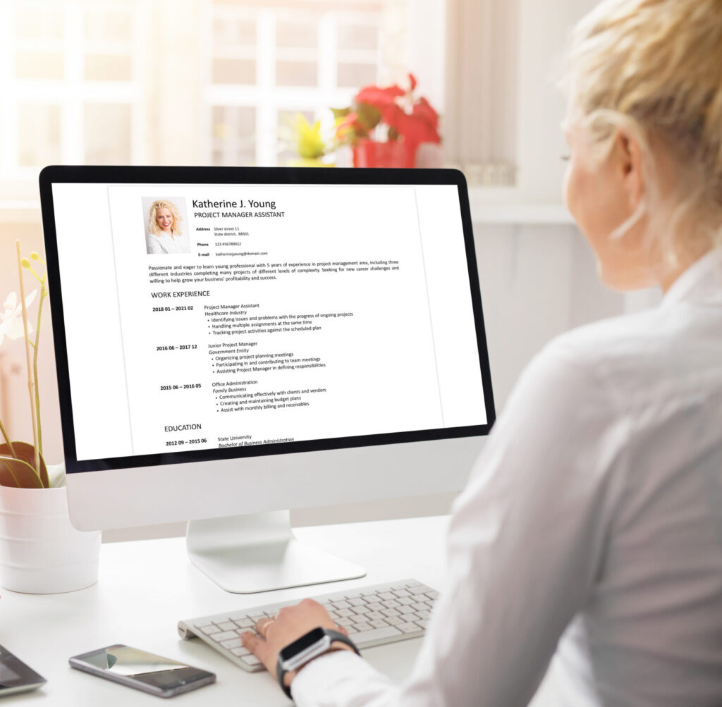 Woman creating her CV on computer. All contents in document are made up.
